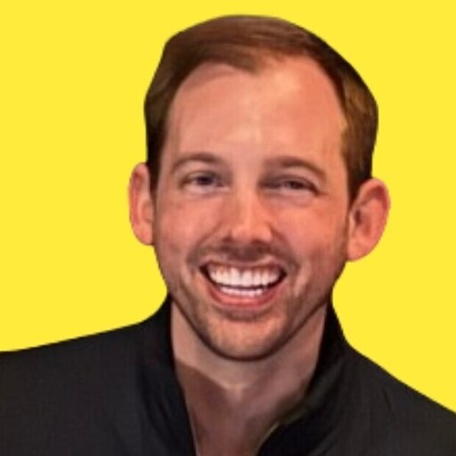 Durkin smiling against a yellow background